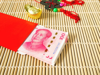Stack of Chinese yuan money in red envelope