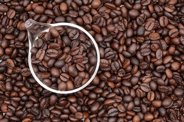 
Closeup coffee bean background with glass spoon.