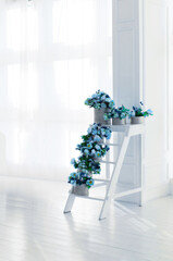 Bouquets of roses on a white staircase. Interior decor.