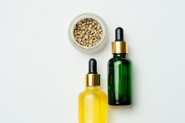 Marijuana cosmetic products, CBD oil. Medicinal hemp extract in cosmetic bottles on white background. Natural herbal care, medical usage, cannabis therapy.