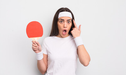 pretty hispanic woman looking surprised, realizing a new thought, idea or concept. ping pong concept