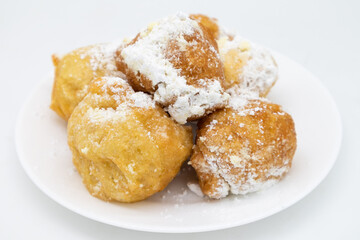 Italian Zeppole Donuts with Powdered Sugar on a White Plate