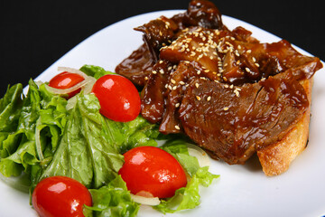Steak. Beef on toast with demiglace sauce. close-up