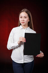 Asian girl holding sign on black background