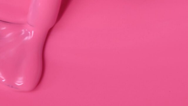 Pink gel nail polish. brush movement. Manicure cover