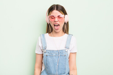 pretty young woman with cheerful and rebellious attitude, joking and sticking tongue out. listening...
