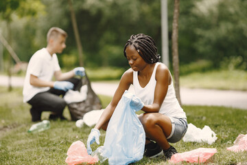 Young volunteers cleaning the rubbish in park