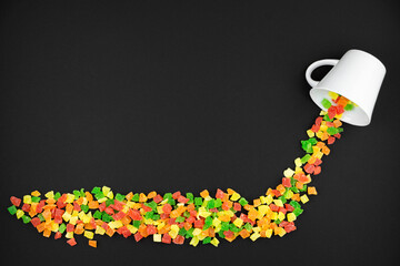 multicolored candied fruits from a white cup