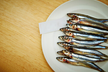 raw anchovies on a plate 