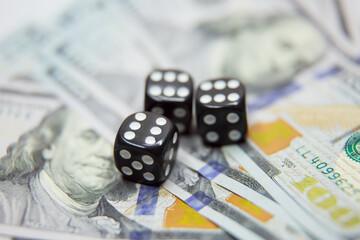 casino, gambling and fortune concept - close up of black dice and dollar cash money