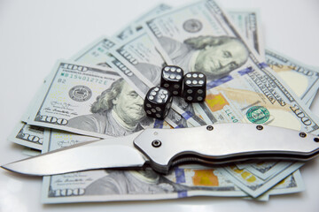 American dollars with a game bone and a knife