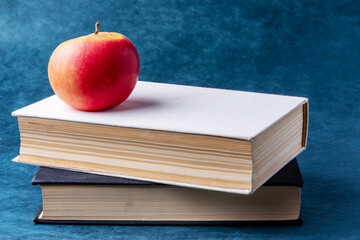 stack of books and apple