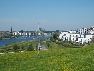 View of Phoenix Lake in the Dortmund suburb of Hoerde, North Rhine-Westphalia, Germany, a renatured industrial wasteland, in the background the Dortmund TV tower © Guenter