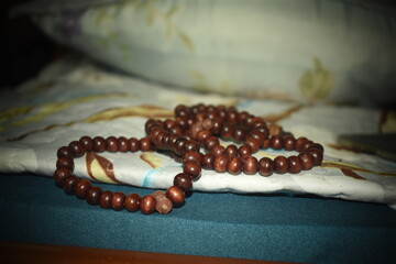 a string of beads used in praying and meditating 