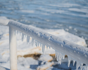 frozen metal railing with hanging ice