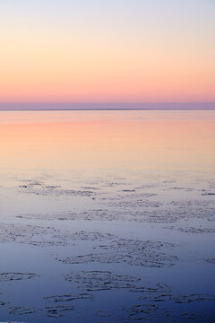 sunset afterglow at the sea with ice in the water