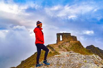 woman looking at mountain and structure