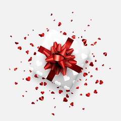 White gift box with beautiful red bow. Red foil confetti. Valentine's day.