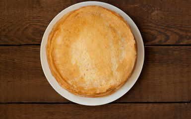 A stack of pancakes in a white plate