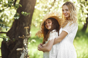 Two cute girls outdoor. Pretty sisters having fun together.