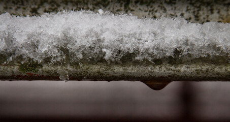 water drop on old metal in snow