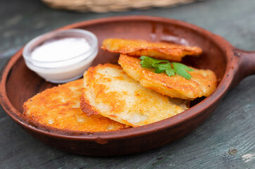Fried grated potato pancakes with sour cream