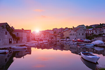 Sunset over sea Vrboska village, Hvar island, Dalmatia, Croatia, Europe. Pink and purple colors....