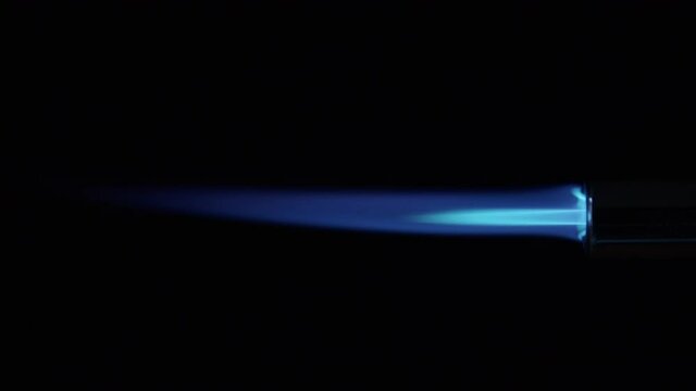 Butane Gas Flame and nozzle against black from a butane torch burner. 50 FPS. Blue and yellow flame. Element for VFX and Compositing, e.g. as rocket propulsion, spaceship drive or welding flame