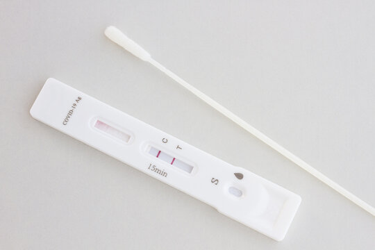 COVID-19 rapid antigen test with swab showing positive result