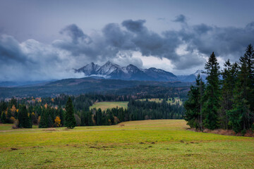 Fototapeta premium A cloudy sunrise on the meadow under the Tatra Mountains at autumn. Poland