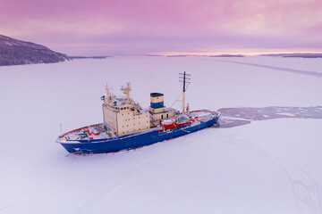Icebreaking vessel in Arctic with background of sunset