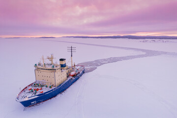 Icebreaking vessel in Arctic with background of sunset