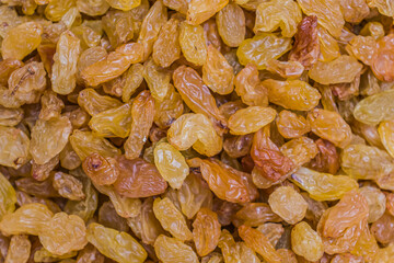 Yellow dried grapes background. Delicious healthy food.