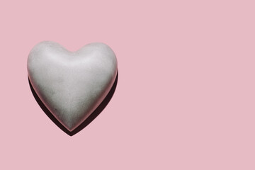 Concrete/plaster heart on pastel pink background. Minimalist Valentines Day Concept.Love background.