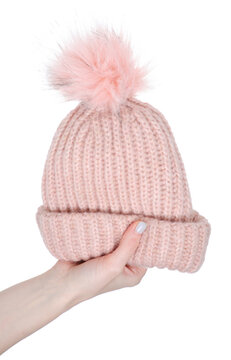 Pink warm hat for girls in hand on white background isolation