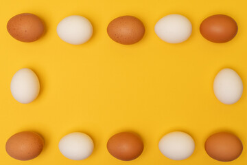 Easter eggs on a yellow background, place for an inscription in the center