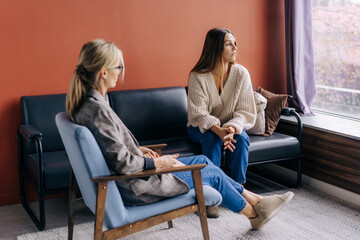 A suffering sad woman on a visit to a psychologist talks about her problems. Help of psychology in solving problems in mental health.