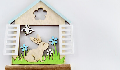 Happy Easter greeting card, holiday invitation. Fairy-tale house with an Easter bunny peeping out...