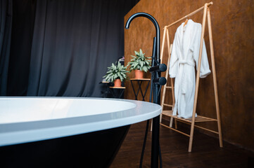 Close up of black bath in bathroom with modern interior