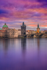View from the Vltava river of the Charles Bridge in Prague, Czechia at sunrise. Colorful clouds