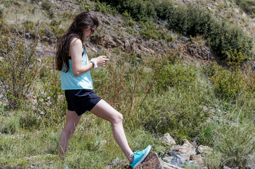 young sporty girl using her cell phone on the field.