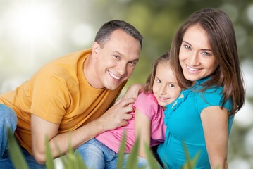 Fototapeta premium happy family with children having good time sitting on the grass in city park