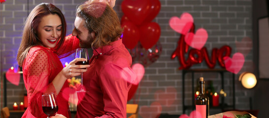 Happy young couple drinking wine and dancing in cafe on Valentine's Day