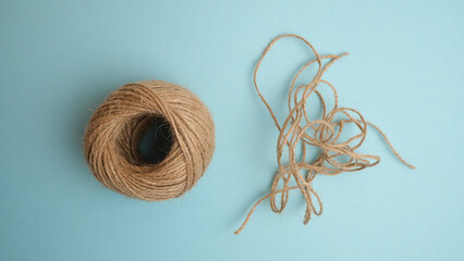 A ball of threads on a blue background. Thread cuttings. Contrast, difference. - obrazy, fototapety, plakaty