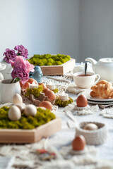 Naklejka na ściany i meble Cozy elegant festive table decor for Easter in a light tone. handmade macrame products, eggs.