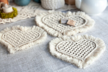 A set of macrame napkins in the form of hearts, made of light cord, handmade