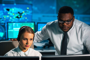 Aircraft flight control officer monitors the approach of aircraft from control tower. Air services...