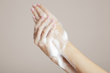 Soap hands in foam beauty health on a beige background