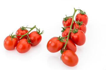 Bunchs of red cherry tomatoes , datterino tomato type isolated on white, copy space