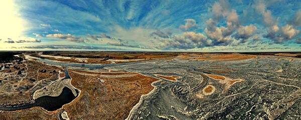 Panorama.View from the top of the backwaters of the Narew river ice-bound in winter.